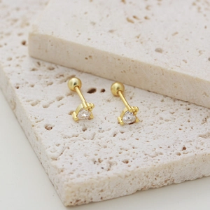 Detailed view of s925 silver gold heart zircon stud earring with screw back on stone pedestal
