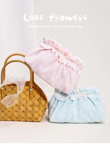 Detailed texture of pink and blue lace storage bags with daisy patterns and bow ties
