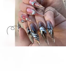 Detail of long stiletto press-on nails with pink ombre and 3D silver liquid metal art