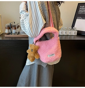 Détail du sac seau en peluche rose avec pendentif ours en peluche et écusson logo