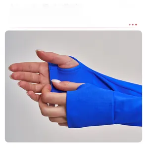 Detail view of electric blue yoga jacket featuring functional thumbhole cuffs for hand protection