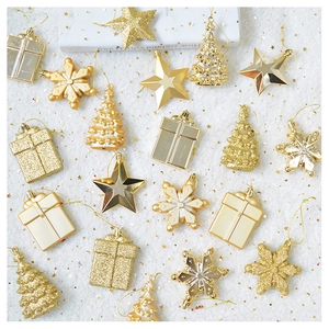 Detailed flat lay of 18 gold star and snowflake ornaments on white faux fur background