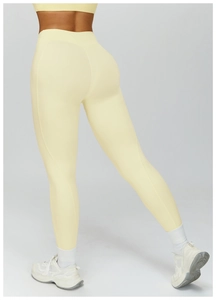 Detailed back view of high-waist yellow yoga leggings with lifting and sculpting effect
