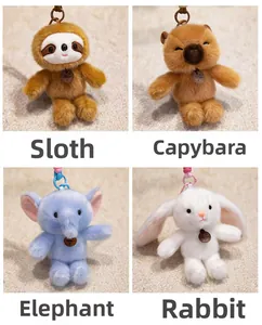 Close-up of plush elephant, rabbit, and capybara keychains with leather fashion tags