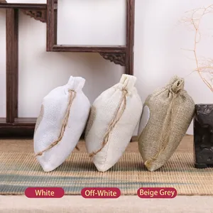 Handmade linen drawstring gift bags with heart patch in white, off-white, and beige-grey