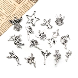 Macro view of vintage silver angel charms and cupid pendants for DIY jewelry making