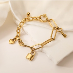 18K gold plated charm bracelet with heart, lock, and key pendants on a mixed chain