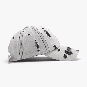 Distressed grey denim baseball cap with patchwork details and gothic embroidery