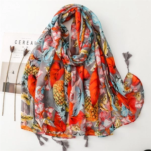 Tropical fruit scarf with colorful pineapple leaves print and tassels on grey background