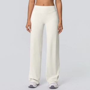 Detail of high-waisted cream yoga pants with wide-leg cut and soft drape fabric