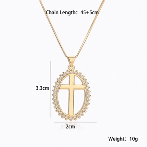 Detail of gold plated cross pendant necklace featuring white cubic zirconia accents
