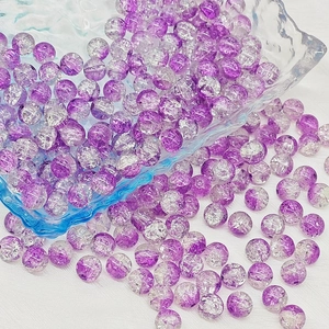 Macro shot of 6mm and 8mm purple cracked glass beads for DIY jewelry making and crafts