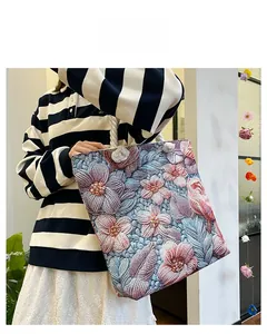 Detail of multi-color floral jacquard fabric and thick cotton rope handle on tote bag