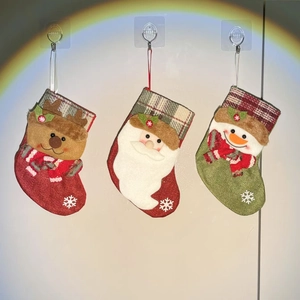 Detailed close-up of three 3D Christmas stockings featuring Santa, reindeer, and snowman