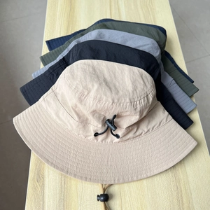 Stack of quick-dry sun protection bucket hats in five colors with adjustable chin straps