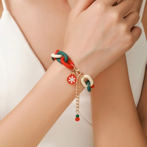 Detailed shot of Christmas bracelet featuring red snowflake pendant and acrylic links