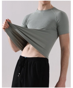 Close-up of gray-green fitness t-shirt showing high elasticity and breathable mesh fabric