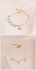 Close-up of stainless steel pearl bracelets with Tree of Life and star enamel charms