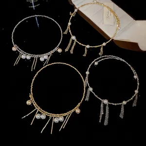 Elegant pearl choker set with cascading metal tassels in gold and silver finish