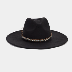 Detailed view of bohemian blue and white beaded band on black wide brim felt fedora hat