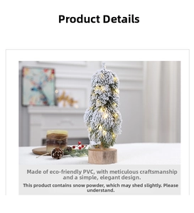 Mini tabletop Christmas tree with flocked snow effect and warm LED lights on a wooden base