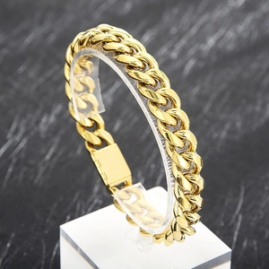 Polished 12mm golden titanium steel Cuban link bracelet on a professional display stand