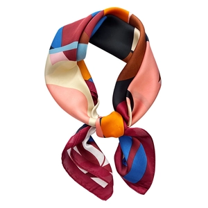 Silk-like satin scarf with colorful geometric patchwork pattern on a white background