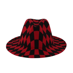 Detailed view of wide brim wool fedora with red and black checkered pattern and flat brim
