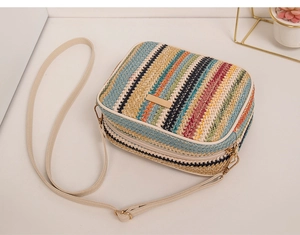 Detailed view of colorful rainbow woven texture and gold metal plate on a crossbody bag