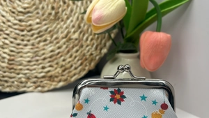 Close-up of Christmas cat pattern coin purse with a vintage silver metal clasp closure