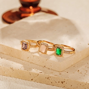 Detailed view of three 18K gold-plated adjustable rings with colorful zircon gemstones