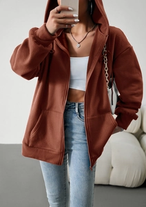Close-up of brown polar fleece hoodie with zipper detail and soft texture material