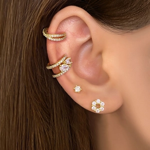 Close-up of gold-plated ear cuff set with zirconia star and flower cluster studs