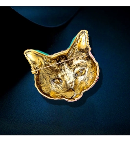 Detail view of the gold-plated cat brooch back showing needle pin clasp and metal texture