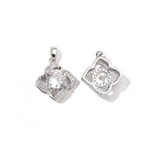 Detail of silver clover pendant with central round zircon and hollow back design