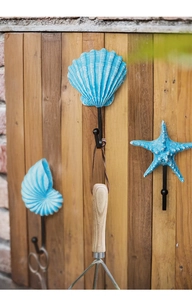 Nautical resin wall hooks set with starfish and shell designs on rustic wood background