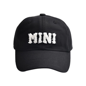 Close-up of black cotton baseball cap featuring white towel embroidered MINI text detail