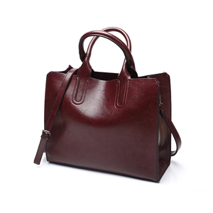 Burgundy faux leather tote bag detail with sturdy top handles and adjustable strap