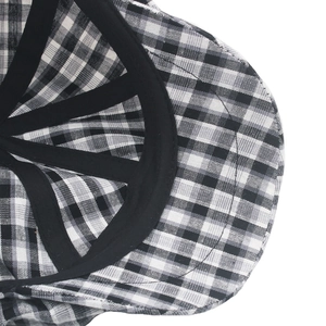 Close-up of black and white checkered cotton beret featuring clean stitching and sweatband