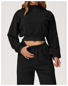 Detail view of black cropped hoodie and matching joggers with ribbed cuffs and hem