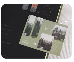 Close-up of magnetic bookmarks featuring jungle trees and snowy mountain designs