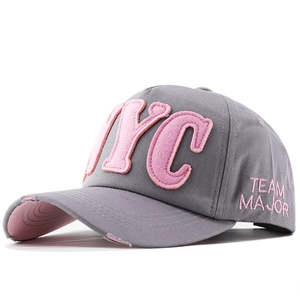 Detail of grey distressed baseball cap with pink NYC 3D embroidery and frayed brim
