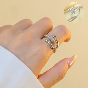 Close-up of silver horseshoe ring featuring micro-pave cubic zirconia on model finger
