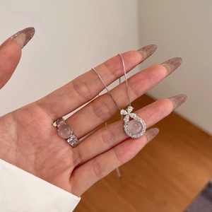 Detail showing elegant S925 silver necklace and ring set with pink stones and diamonds