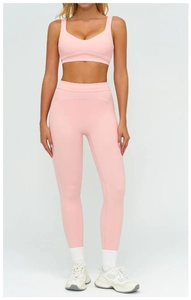 Détail de l'ensemble de yoga rose avec brassière en U et legging aux coutures blanches contrastées