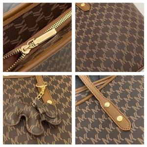 Detail of dark brown tote bag with M-pattern, gold zipper and dog-shaped leather charm