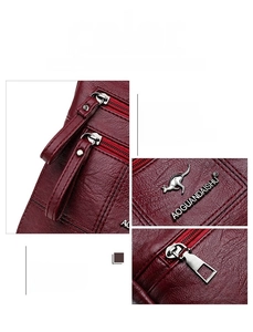 Detail of red pebbled leather bag featuring smooth zippers and adjustable metal hardware