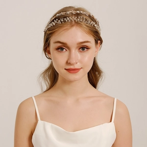 Detailed close-up of handmade gold wire bridal headband with crystals and pearls