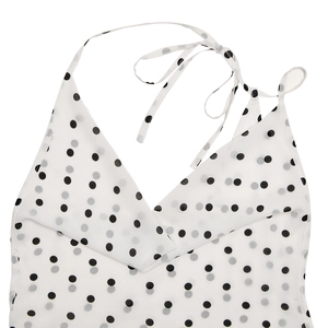 Detail view of white polka dot halter neck dress with adjustable self-tie back straps