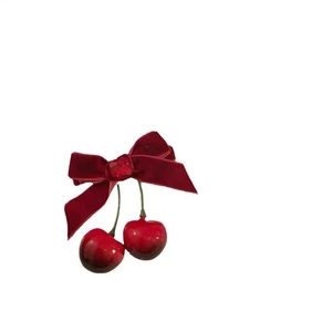 Elegant red velvet bow hair clip with glossy cherry pendant and center bead detail